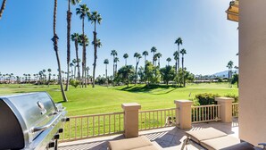 A patio with a grill, lounge chairs, and a view of a golf course. - Patio + Resort Amenities: Palm Desert Escape (Palm Desert)