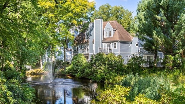 A large house with a pond and a fountain, surrounded by lush greenery. - ROMANTIC SPA RETREAT MINUTES TO MOHEGAN SUN CASINO (Norwich)