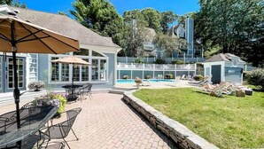 A backyard with a swimming pool, patio furniture, and a small shed. - ROMANTIC SPA RETREAT MINUTES TO MOHEGAN SUN CASINO (Norwich)