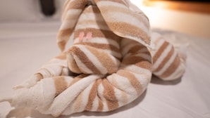 Een bed met een gestreepte deken en een kussen.