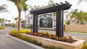A sign for West Lucaya Village Resort with a pergola structure. - Beautiful Town Home in Gated Community With Amenities - Close to WDW (Kissimmee)