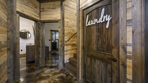 A wooden interior hallway with a door labeled "laundry". - Game Room, Hot Tub, Fire Pit, Pets, High Horse (Broken Bow)
