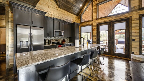 A spacious kitchen with a large island, stainless steel appliances, and a view to the outside. - Game Room, Hot Tub, Fire Pit, Pets, High Horse (Broken Bow)