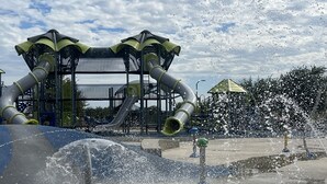 A water play area with multiple slides and water jets.