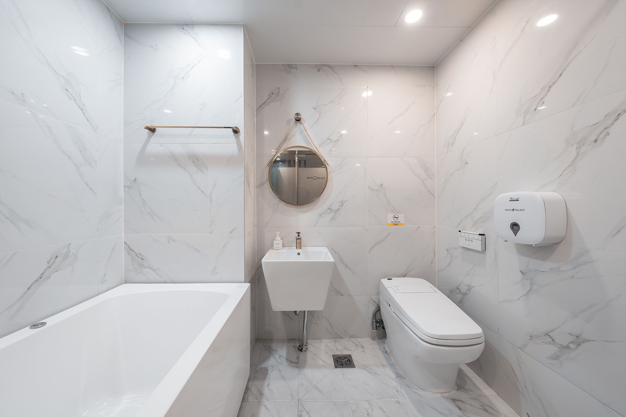 A modern bathroom with a bathtub, a sink, and a toilet.