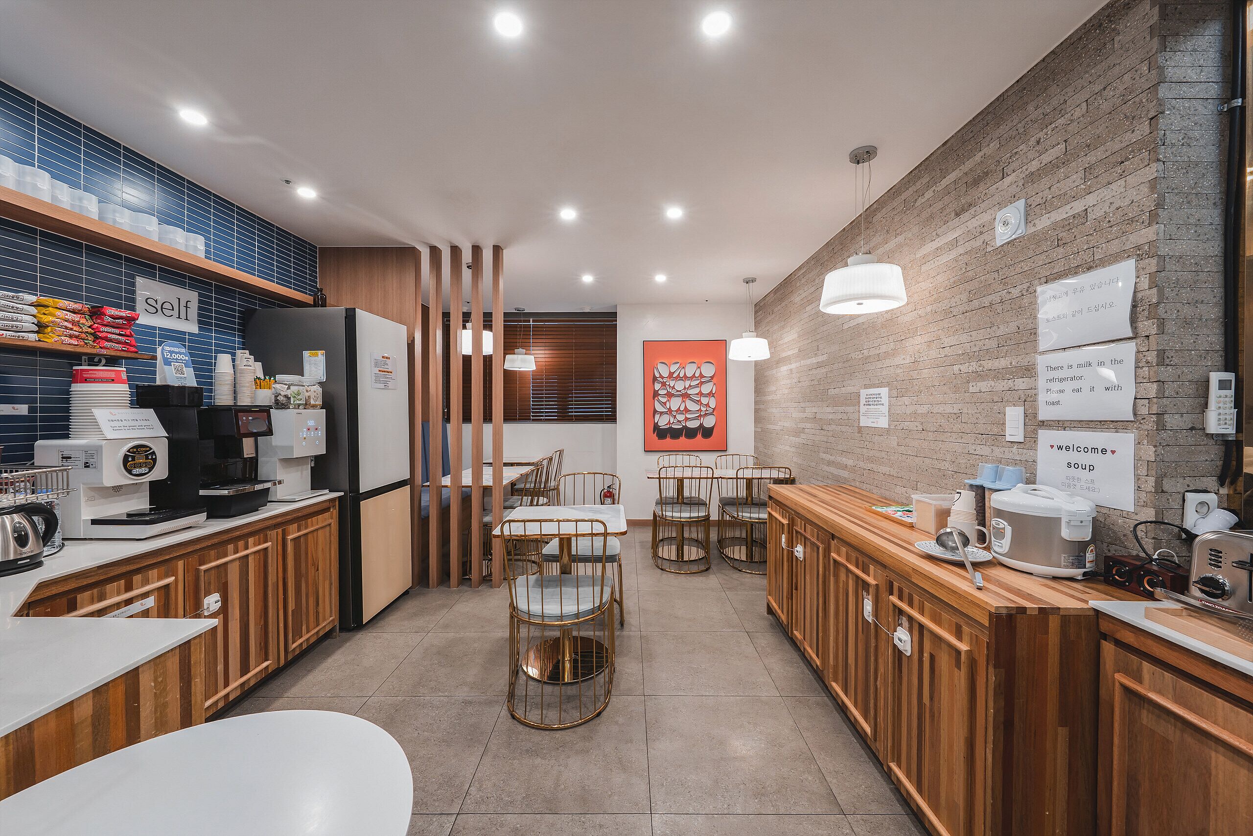 A modern cafe with wooden counters, seating, and a coffee machine.