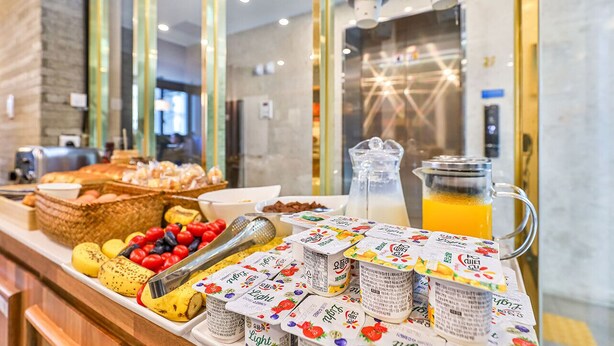 A buffet with various food items and beverages, including yogurt, fruits, and a pitcher of orange juice. - Hotel Palace Gyeongju (Gyeongju)