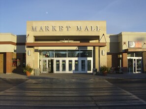 A building with a sign reading "MARKET MALL" and a number "4" above the entrance.