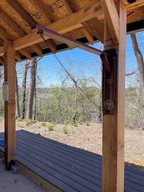 A wooden deck with a view of a natural landscape.