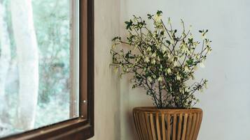 A wooden planter with a plant on a windowsill.