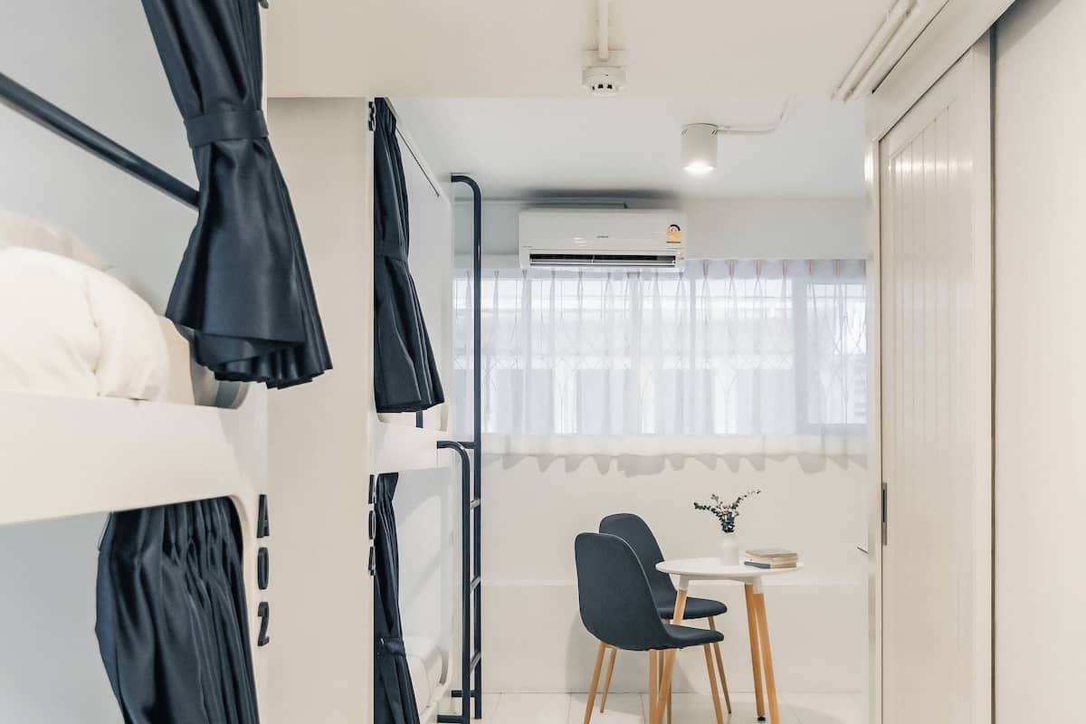 Habitación de hotel moderna con literas, un escritorio y una silla.