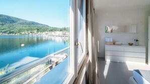 Un balcon avec vue sur un lac et sur le paysage urbain.