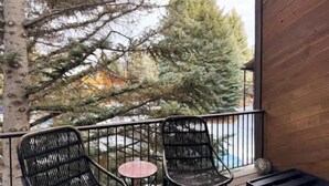 A balcony with two black metal chairs and a small round table. - Canyons Resort - Walking Distance Sunrise Gondola! (Park City)