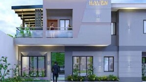 A modern hotel with a prominent 'HAYEN' sign, featuring a two-story structure with large windows and a balcony. - Haven Suite (Lagos)