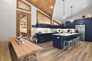 Enjoy meals in the kitchen with a central island, refrigerator, and large window offering a view of the outdoors.