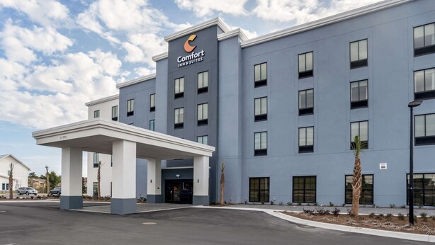 A modern Comfort Inn & Suites building with a flat facade, multiple windows, and a covered entrance. - Comfort Inn & Suites Panama City Beach - Pier Park Area (Panama City Beach)