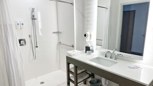 A modern bathroom with a walk-in shower, a vanity with a mirror, and a sink. - Comfort Inn & Suites Panama City Beach - Pier Park Area (Panama City Beach)