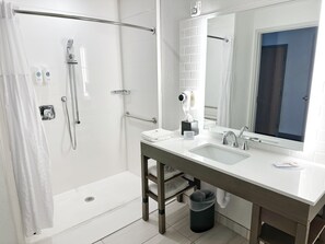 A modern bathroom with a walk-in shower, a vanity with a mirror, and a sink. - Comfort Inn & Suites Panama City Beach - Pier Park Area (Panama City Beach)