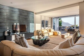 A modern living room with a sofa, coffee table, and a TV.