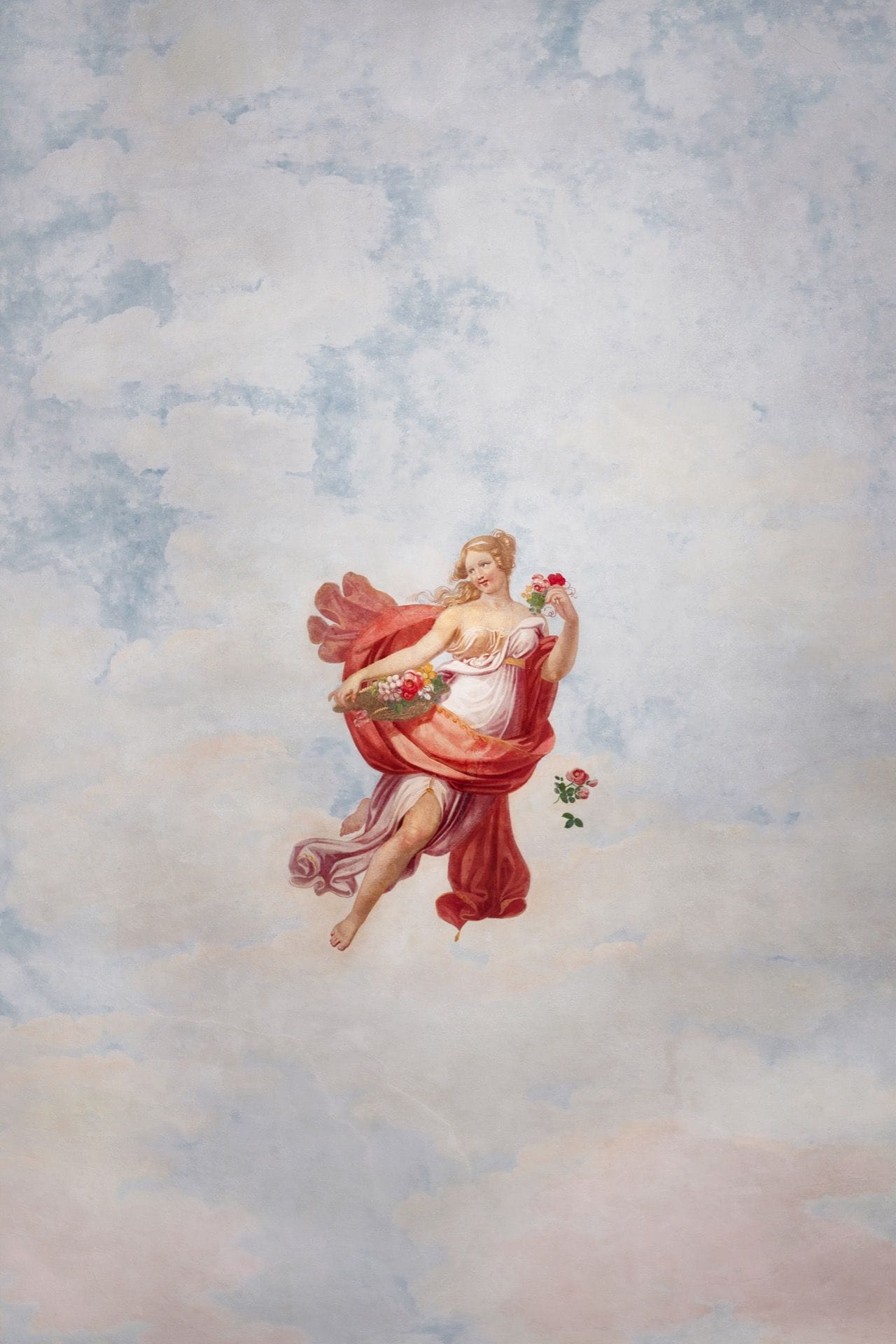 A classical painting of a woman in a flowing dress with a bouquet, set against a cloudy sky backdrop.