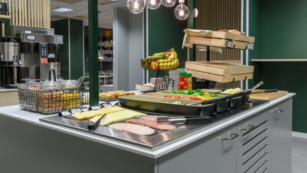 A buffet with various food items and condiments.
