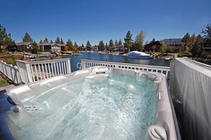 A hot tub with a view of a lake and surrounding houses. - Waterfront Home on Double Lot - Boat Dock, Hot Tub and More! (South Lake Tahoe)