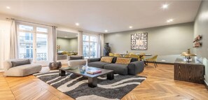 Relax in this stylish living room with a sofa, coffee table, and dining area.