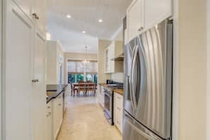 Enjoy meals in the kitchen with a gas stove and dining area overlooking the outdoors through large windows.