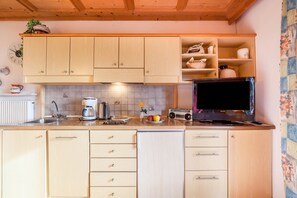 Fridge, stovetop, dishwasher, coffee/tea maker