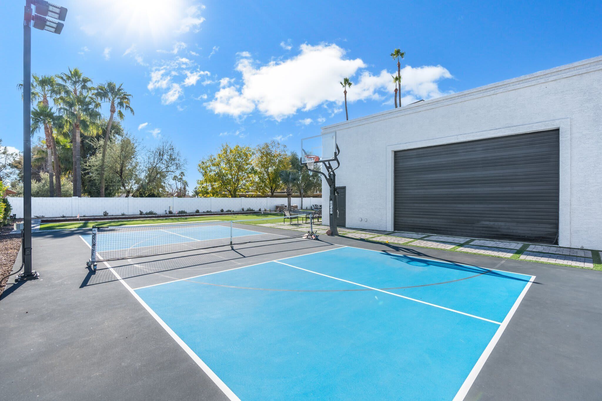 Brand new regulation pickleball court with half basketball and light