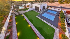 A residential property with a tennis court, swimming pool, and landscaped garden. - Desert Playground | Pool, Gym, Bocce & Pickleball. (Scottsdale)
