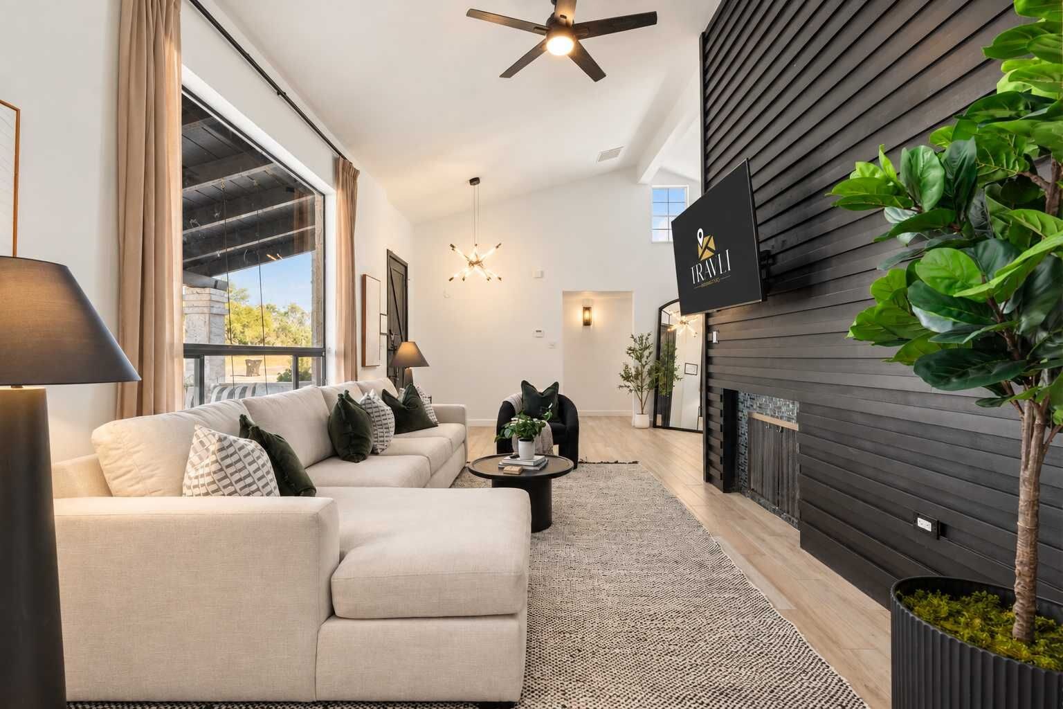 A modern living room with a sofa set, a coffee table, and a fireplace.