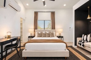 The queen bed sits under a big window with a lamp on each side. A small desk and chair give you a quiet spot to work during your stay. - Desert Playground |Pool|Sportcourt |Bocce | Cabana (Scottsdale)