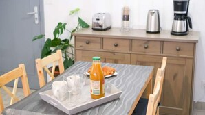 A breakfast tray with orange juice, a croissant, and a glass of water on a table. - Les Chevalets Iv/stade Bollaert/louvre/université (Lens)