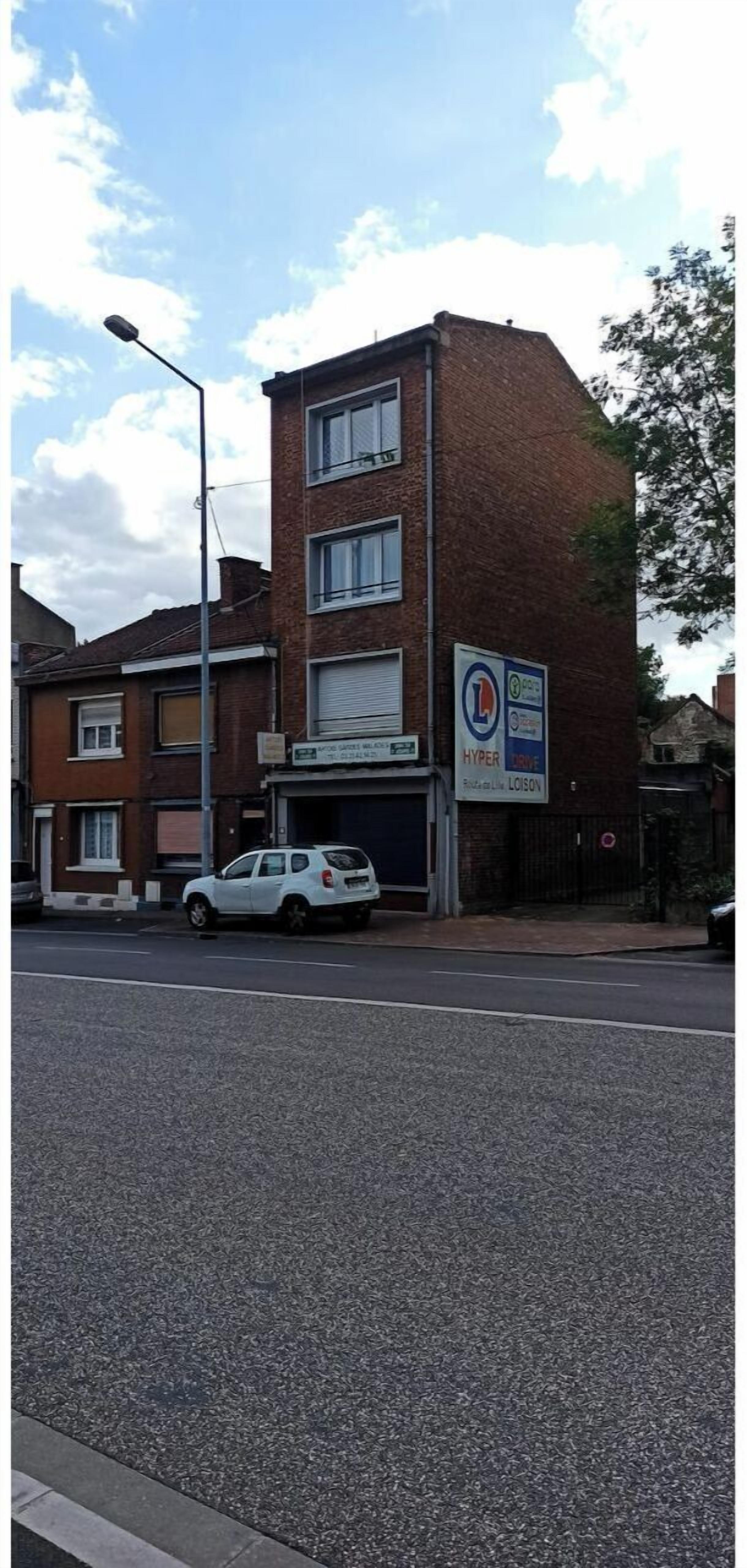 A multi-story building with a sign for 'Hyper Local' and a parked white car in front.