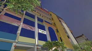 A multi-story building with a visible arcade sign on the top floor. - Treebo Sky 5 (Panchkula)