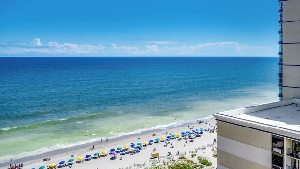 A beach view with a building on the right.