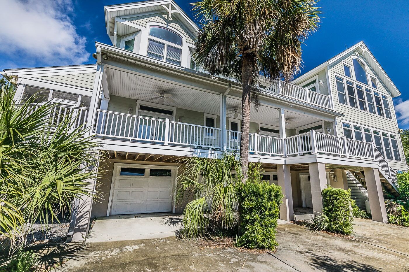 A two-story house with a balcony, a garage, and a staircase leading to the upper level.