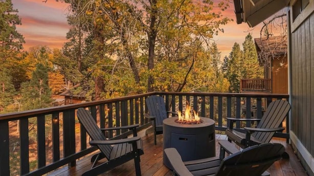 A wooden deck with outdoor seating and a fire pit. - Closer to the Stars Fire Pit Dog-Friendly (Big Bear Lake)