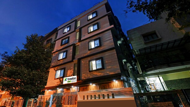 A multi-story hotel with a modern design, featuring a prominent 'treebo' sign on the facade. - Treebo SLN Heritage (Bengaluru)