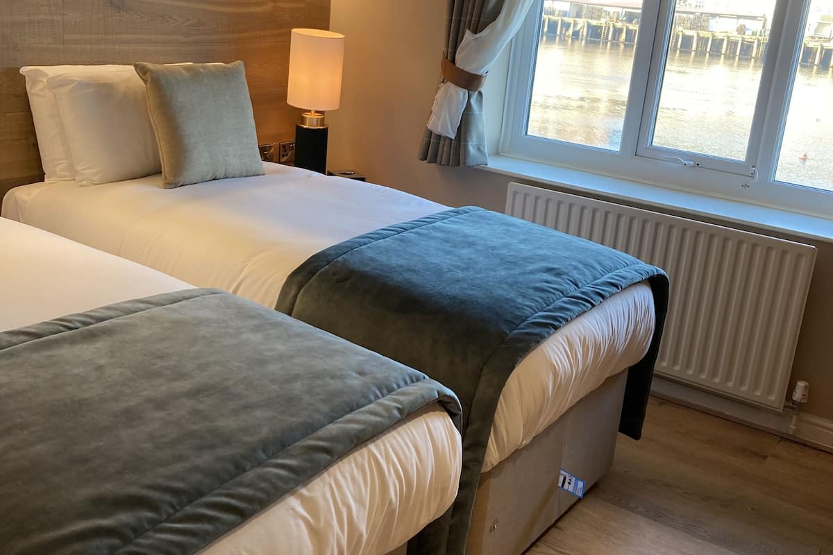 Desk, iron/ironing board, bed sheets