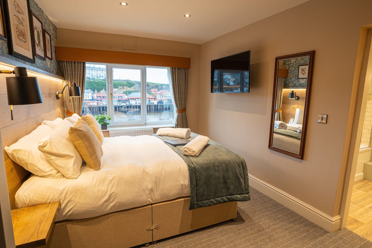 Desk, iron/ironing board, bed sheets