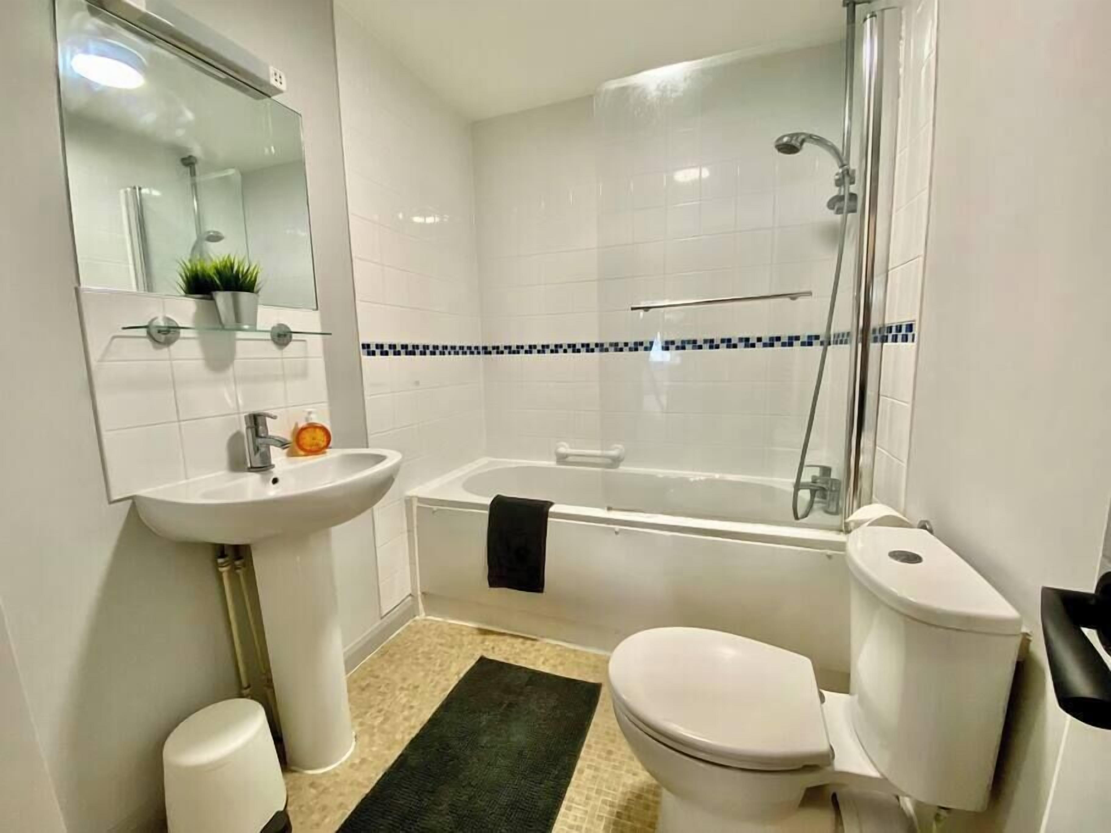 Ein modernes Badezimmer mit Waschbecken, Toilette und Badewanne.
