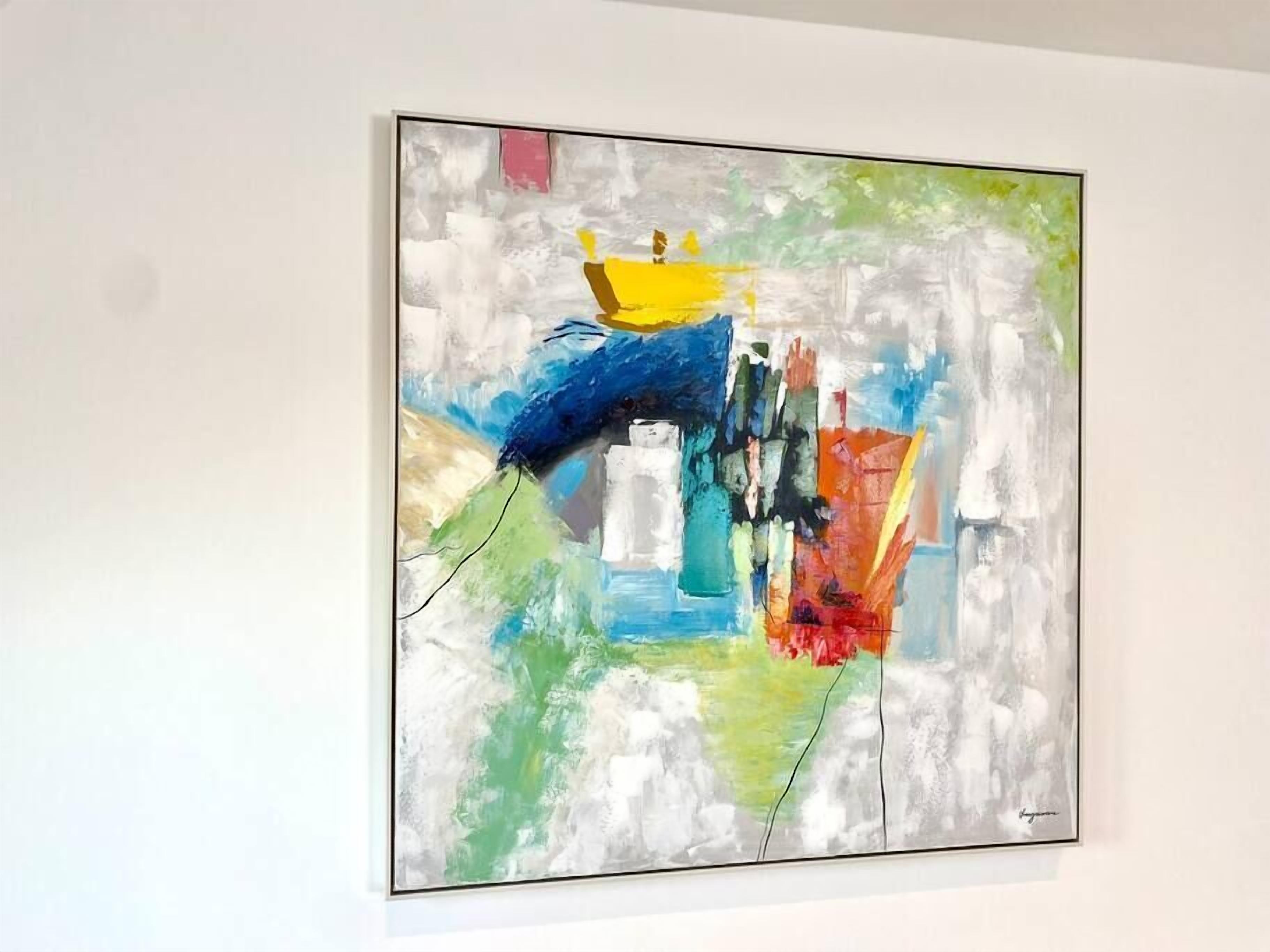 A painting with abstract shapes and colors on a white wall.