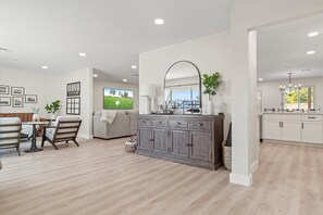 Enjoy a comfortable stay in this spacious room with a dining area, sofa, and large window offering a view of the outdoors.