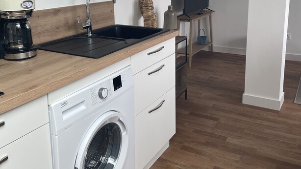 A compact kitchen with a washing machine, a coffee maker, and a sink. - Poulorio 13 proche gare ★ T2 ★ Dernier Etage * By Locly * (Lorient)