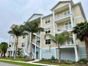 A multi-story residential building with balconies and a central staircase.