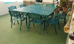 Enjoy meals in this dining area with a rectangular table and lattice-patterned chairs.