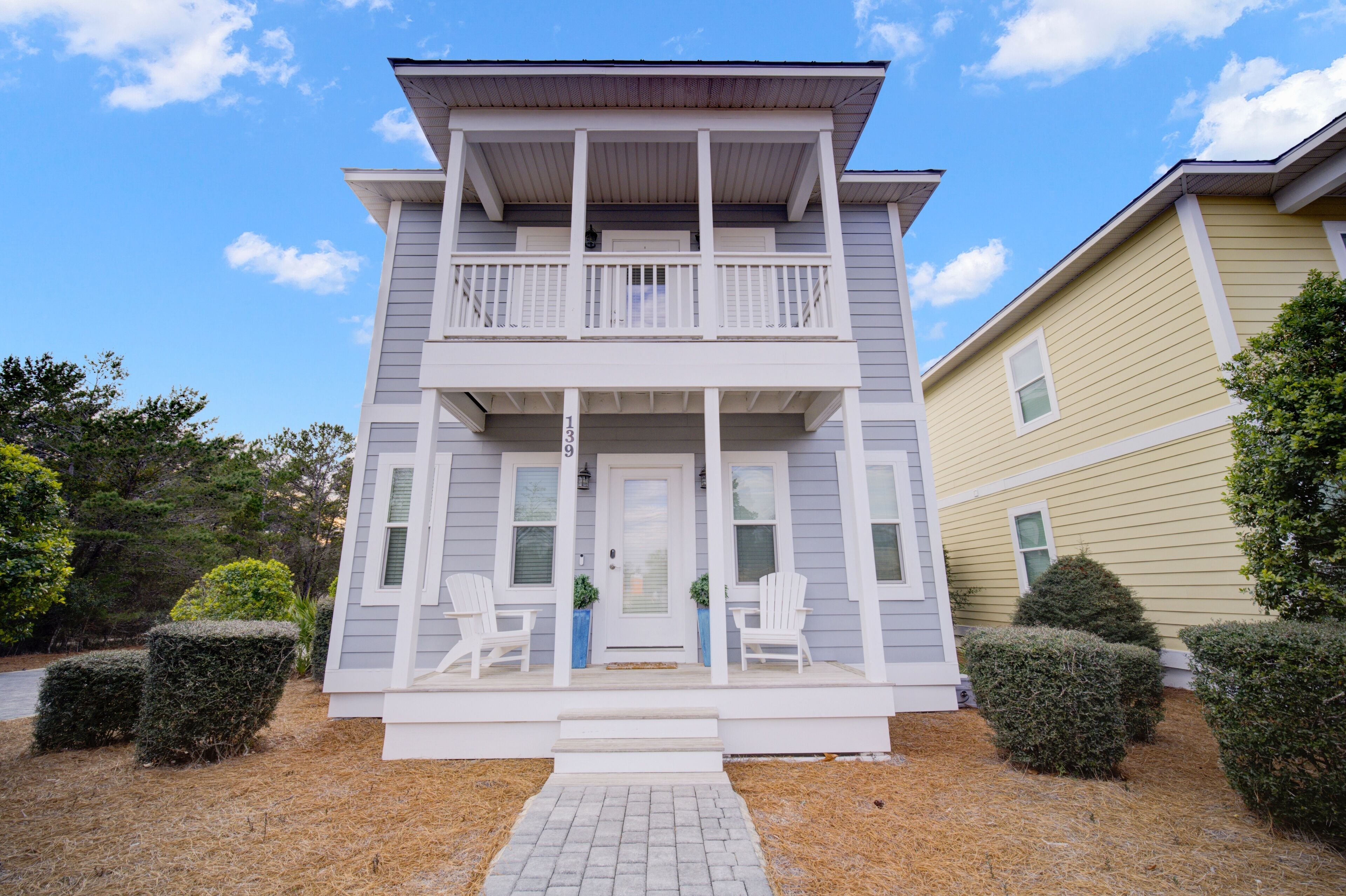 A two-story house with a front porch, a balcony, and a number 9 on the door.
