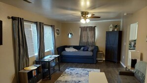 A living room with a sofa, a coffee table, a TV, and a ceiling fan. - NEW!!! The Uptown Oasis...seconds from Uptown Marion!!!  (Marion)
